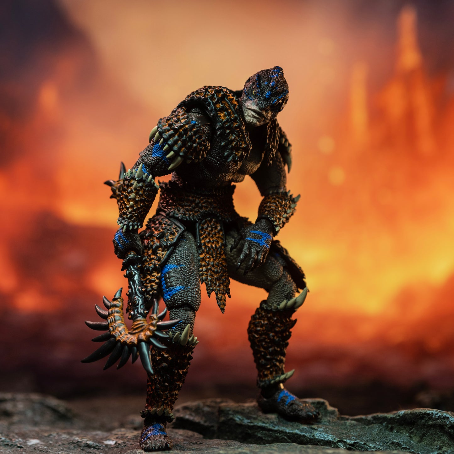 Fully armored brown Lemurian with blue striping casually resting and leaning on left knee with battle axe held low in right hand.