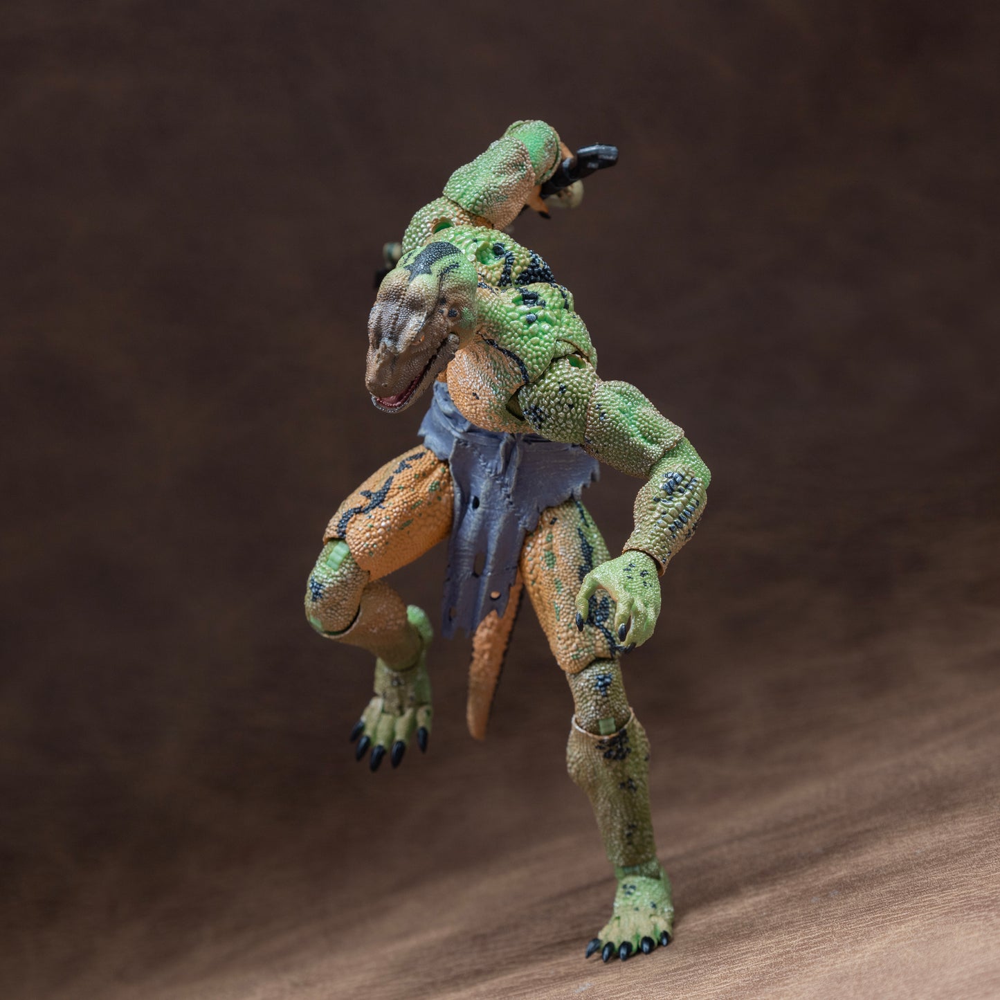 Green, yellow, and black Lemurian in loin cloth running forward and holding mandible club at hip height in right hand.