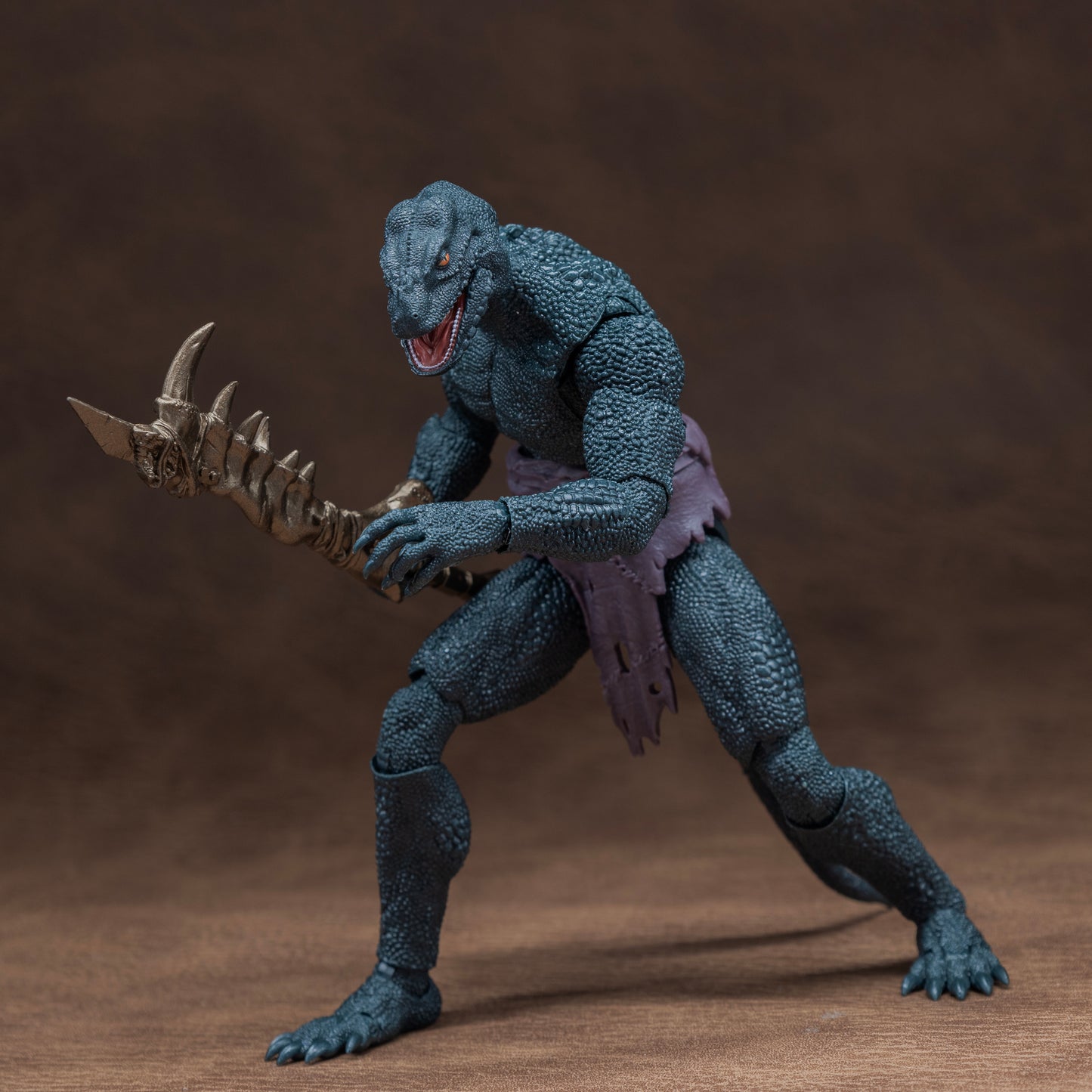 Green Lemurian in loin cloth stalking forward with mandible club held at hip in right hand.